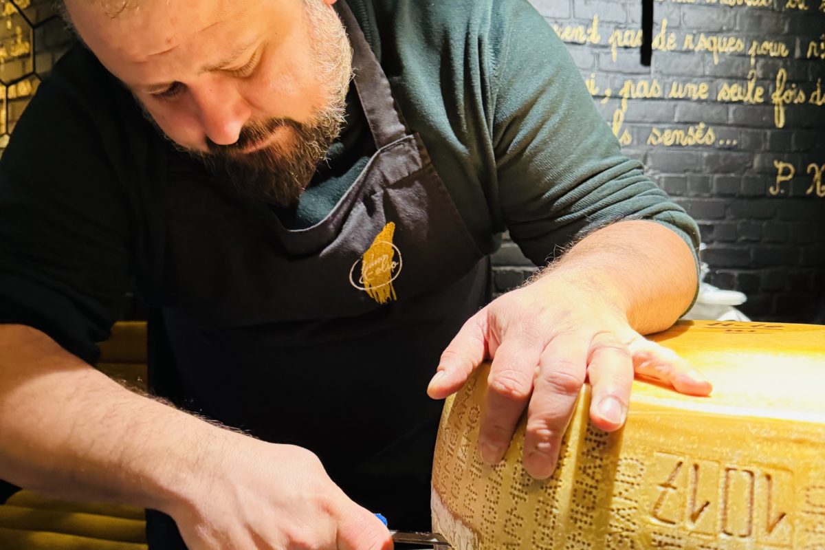 Chef Angelo Galasso opening Parmigiano Reggiano